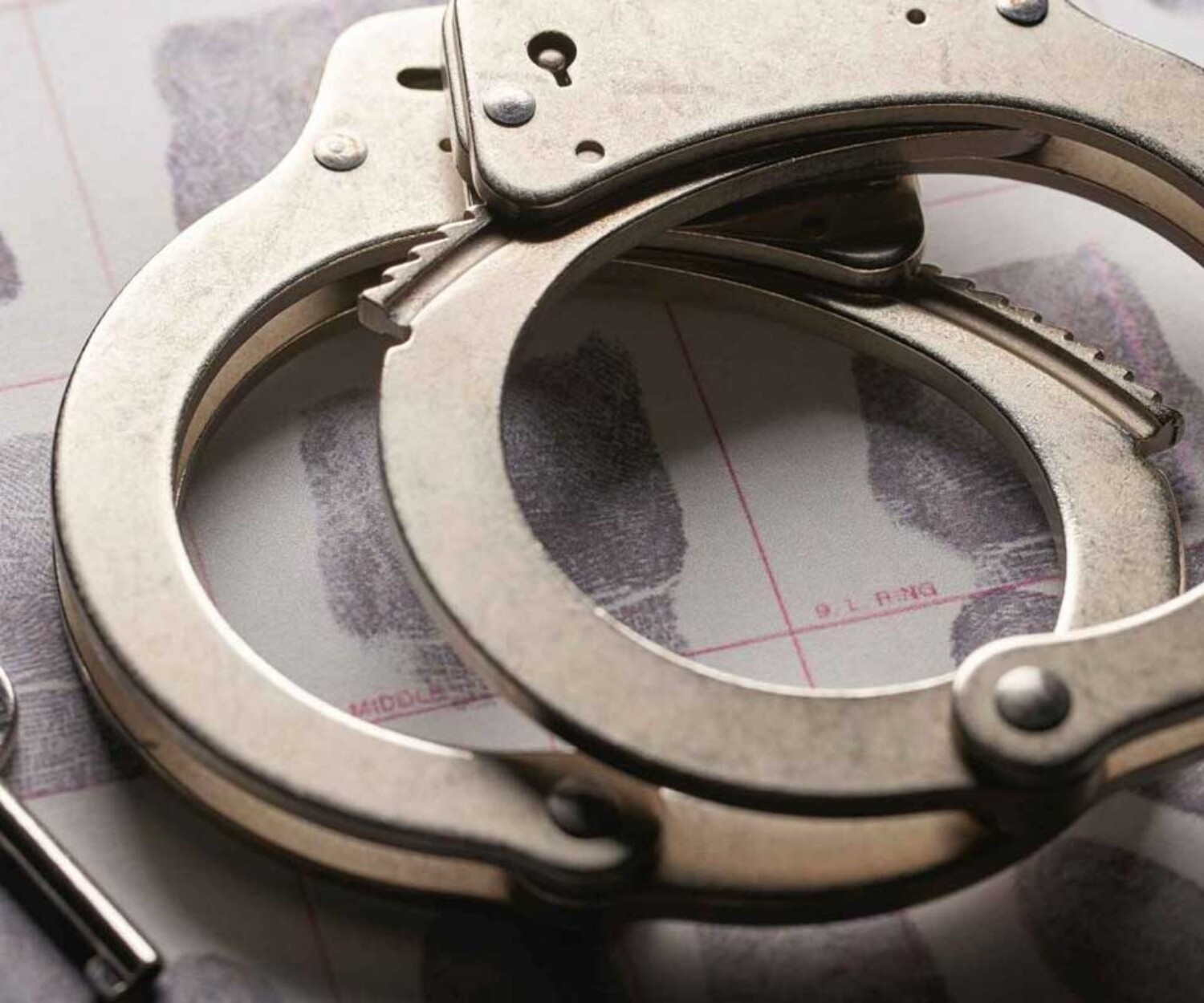 handcuffs-with-key-laying-on-thumbprint-evidence-sheet-resembling-criminal-lawyer-in-jacksonville-florida-available-24-7