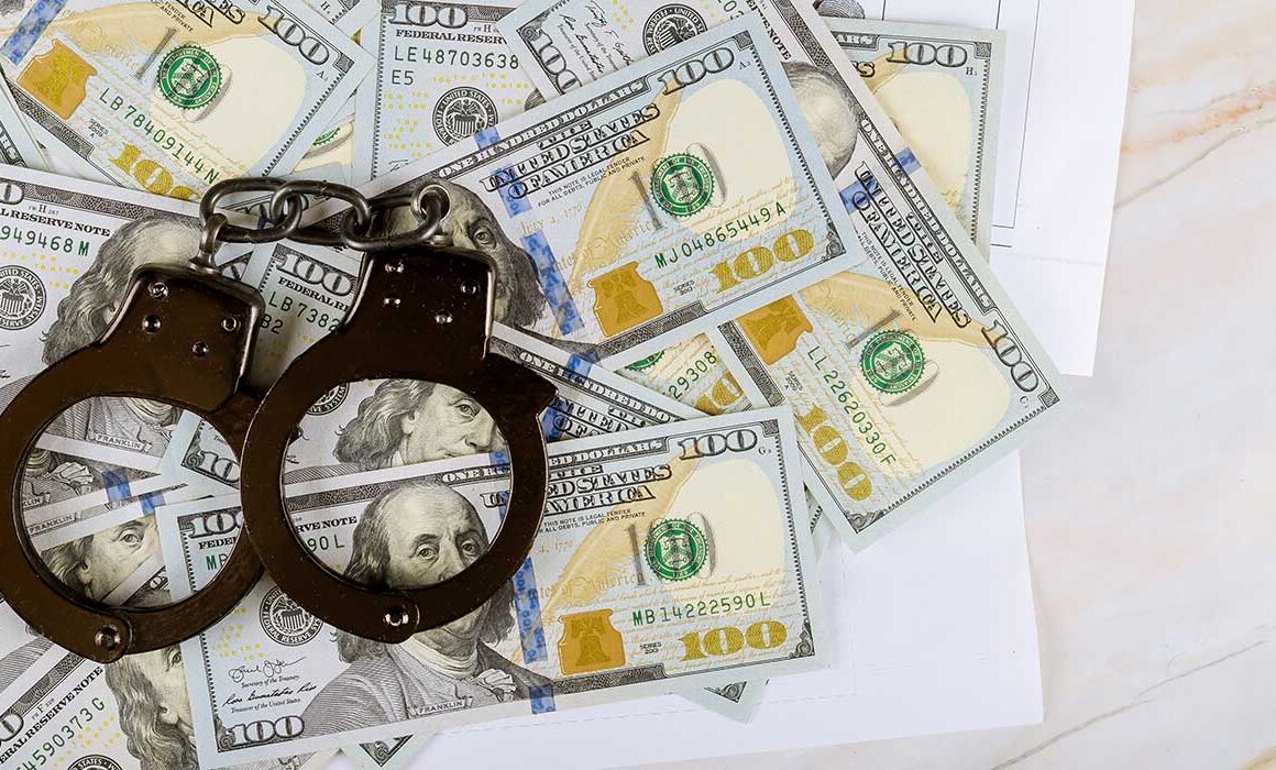 handcuffs-on-top-of-pile-of-money-on-a-desk-in-a-criminal-law-office-in-jacksonville-florida