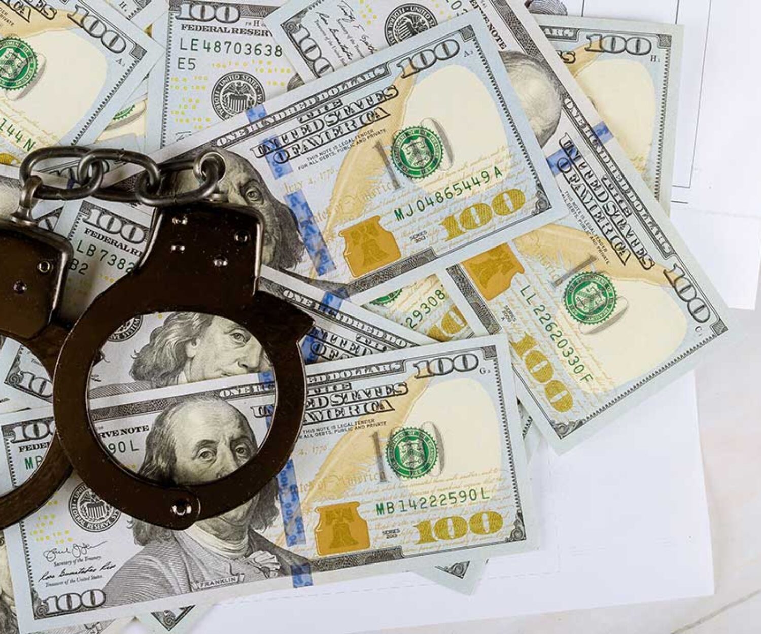 handcuffs-on-top-of-pile-of-money-on-a-desk-in-a-criminal-law-office-in-jacksonville-florida