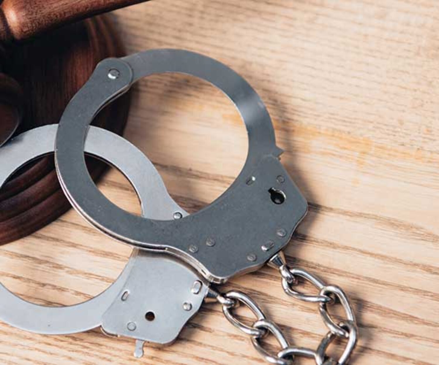 handcuffs-and-gavel-on-desk-in-criminal-law-office