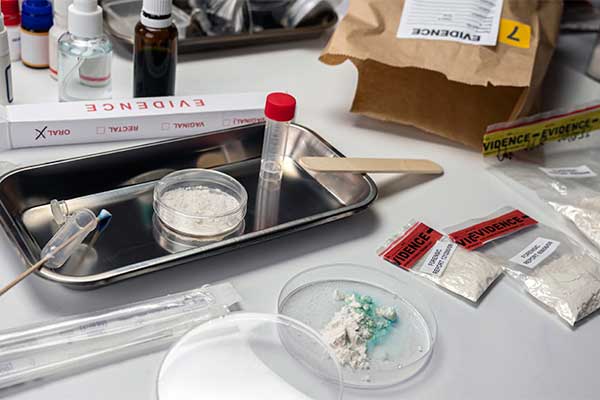 different-drugs-and-testing-material-on-desk-as-part-of-crime-evidence-for-teams-to-review