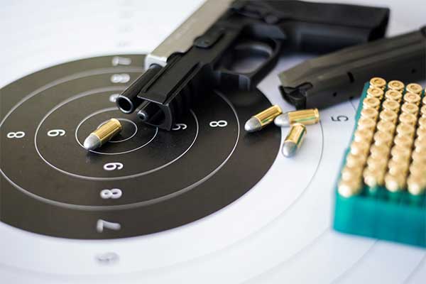 pistol-laying-on-target-sheet-with-bullets-showing-10-20-life-law-from-criminal-defense-lawyer-in-florida