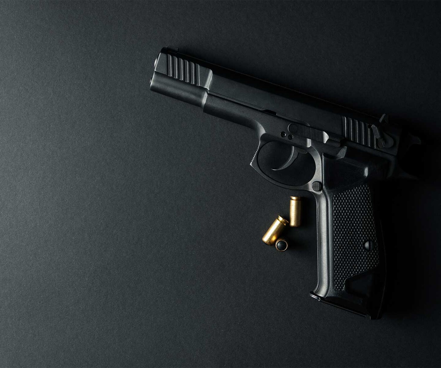 pistol-with-bullet-cases-laying-on-backdrop-as-hero-image-for-criminal-defense-lawyer-in-jacksonville-florida